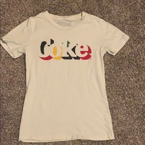 A white shirt that says “Coke”.